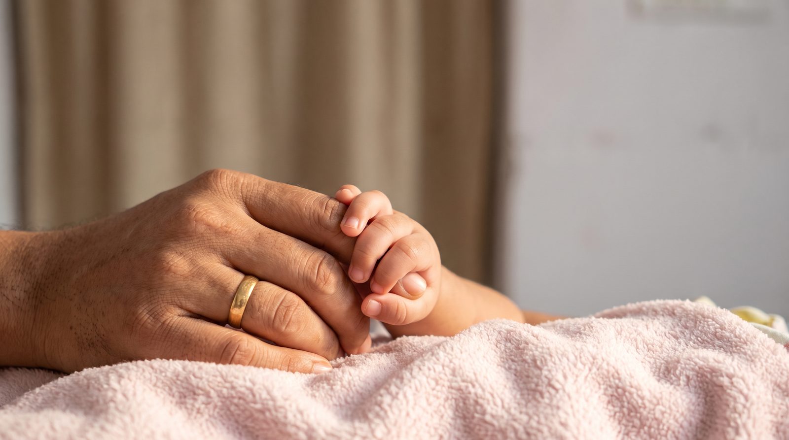 A parent holding a child's hand